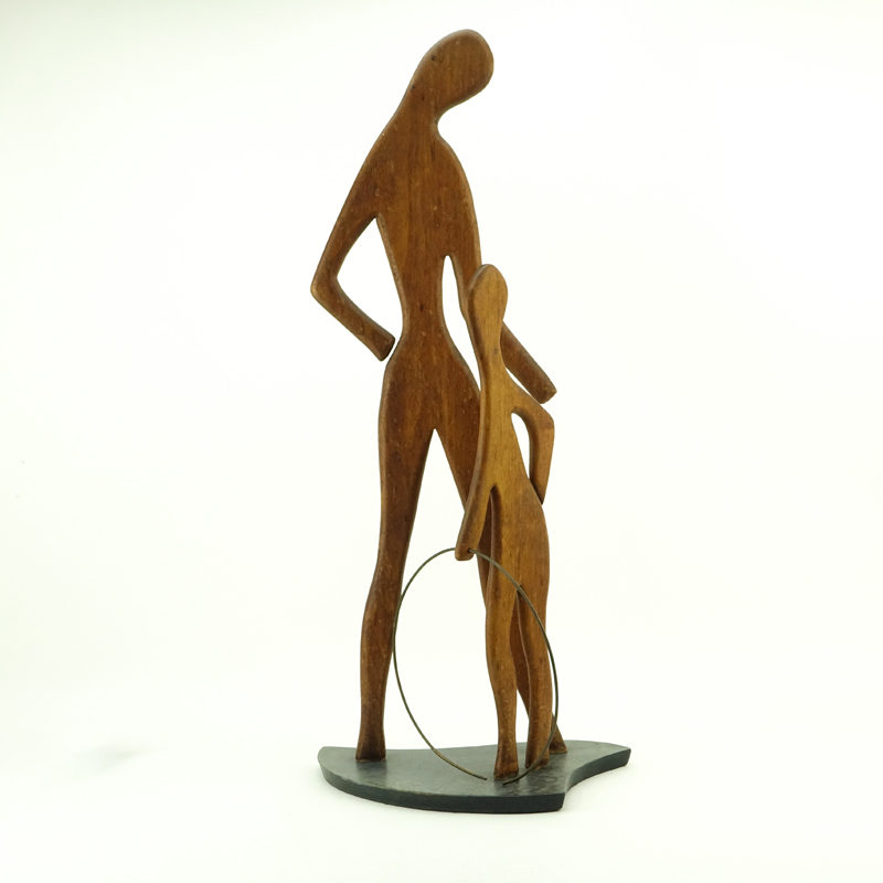 Val Robbins, American (1925-2009) Circa 1950's Carved walnut sculpture "Mother and Son With Hula Hoop". 