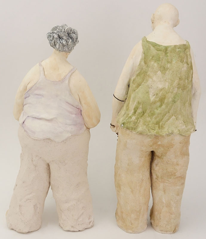 Two Contemporary Pottery Figures. Man And Woman With Sticks.