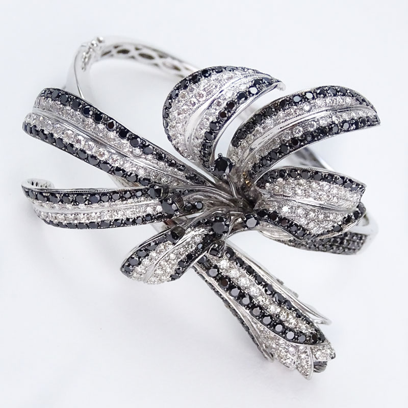 Approx. 7.27 Carat Round Brilliant Cut Black Diamond, 3.74 Carat Pave Set Round Brilliant Cut Diamond and 18 Karat White Gold Flower Hinged Bangle Bracelet. 