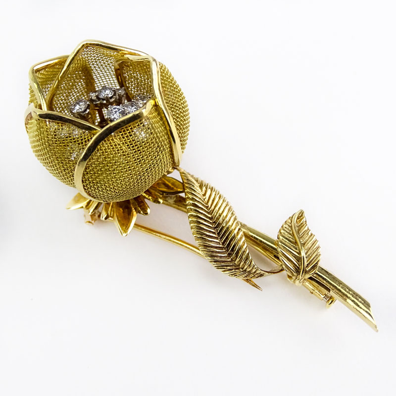 Retro Merrin France Approx. 1.25 Carat Round Brilliant Cut Diamond and 18 Karat Yellow Gold Articulated Flower Brooch.