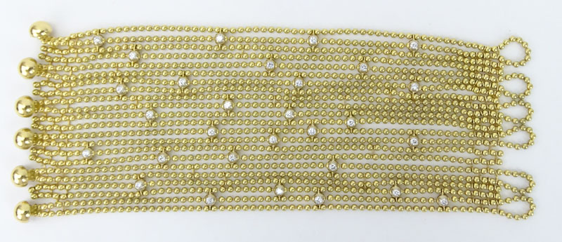 Cartier Round Brilliant Cut Diamond and 18 Karat Yellow Gold Multi Strand Bead Bracelet with original Cartier Box en suite with the previous lot.