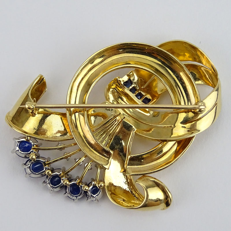 Retro 1950s Cabochon and Calibre Cut Sapphire, .35 Carat Round Brilliant Cut Diamond and 14 Karat Yellow Gold Brooch. 