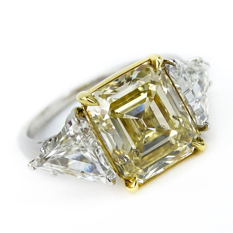 GIA Certified 4.29 Carat Emerald Cut Fancy Yellow Diamond, 1.81 Carat TW Trillion Cut White Diamond, Platinum and 18 Karat Yellow Gold Engagement Ring. 