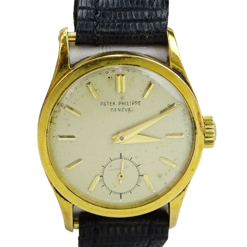 Vintage Patek Philippe 18 Karat Yellow Gold Manual Movement Watch with Leather Strap and 18 Karat Yellow Gold Buckle.