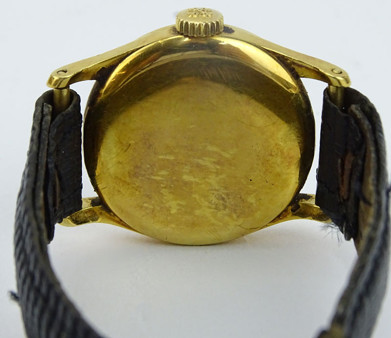 Vintage Patek Philippe 18 Karat Yellow Gold Manual Movement Watch with Leather Strap and 18 Karat Yellow Gold Buckle.