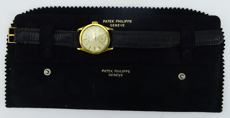 Vintage Patek Philippe 18 Karat Yellow Gold Manual Movement Watch with Leather Strap and 18 Karat Yellow Gold Buckle.