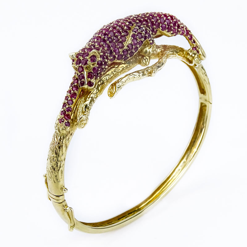 Approx. 13.0 Carat Pave Set Burma Ruby and 14 Karat Yellow Gold Panther Hinged Bangle Bracelet.