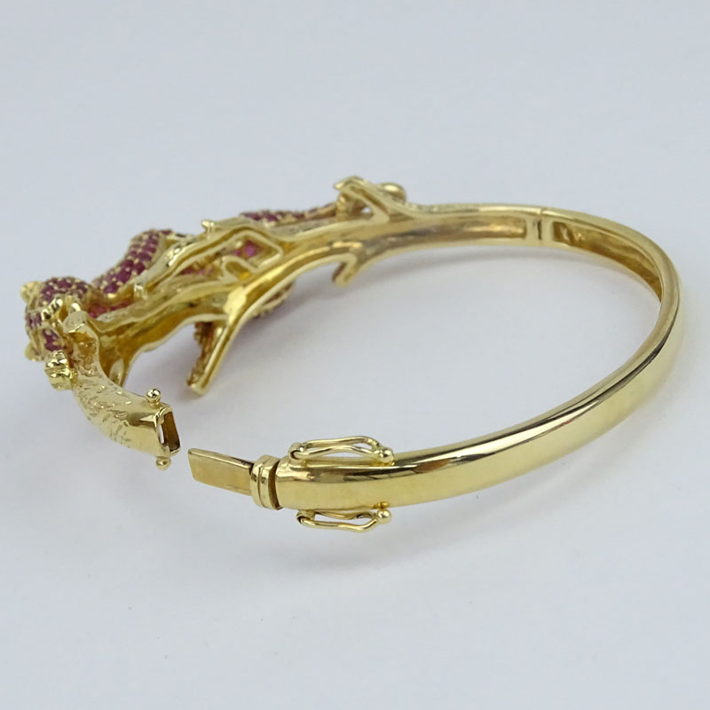 Approx. 13.0 Carat Pave Set Burma Ruby and 14 Karat Yellow Gold Panther Hinged Bangle Bracelet.