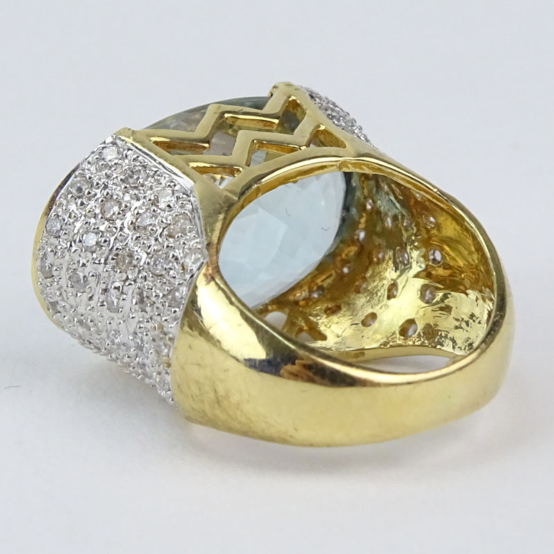 Oval Criss Cross Cut Aquamarine, Pave Set Diamond and 14 Karat Yellow Gold Ring. 