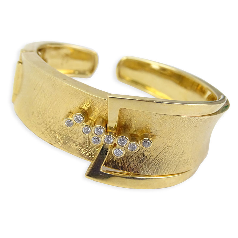 Vintage Sonia Britton 14 Karat Yellow Gold Hinged Bangle Bracelet with 10 Round Cut Diamond Accents.