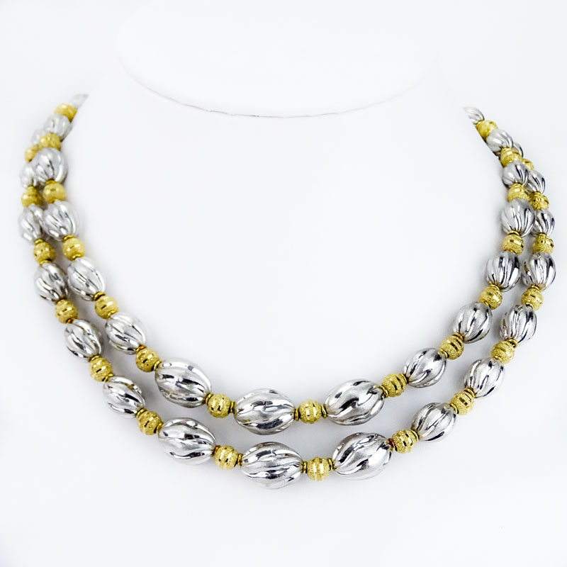 Long Single Strand 18 Karat Yellow and White Gold Graduated Bead Necklace.