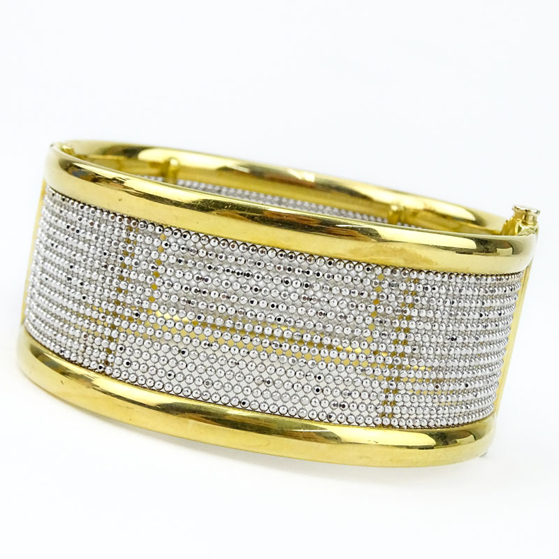 Finely Crafted Italian 18 Karat Yellow and White Gold Hinged Bangle Bracelet. Stamped Italy, 18K and maker's mark. 