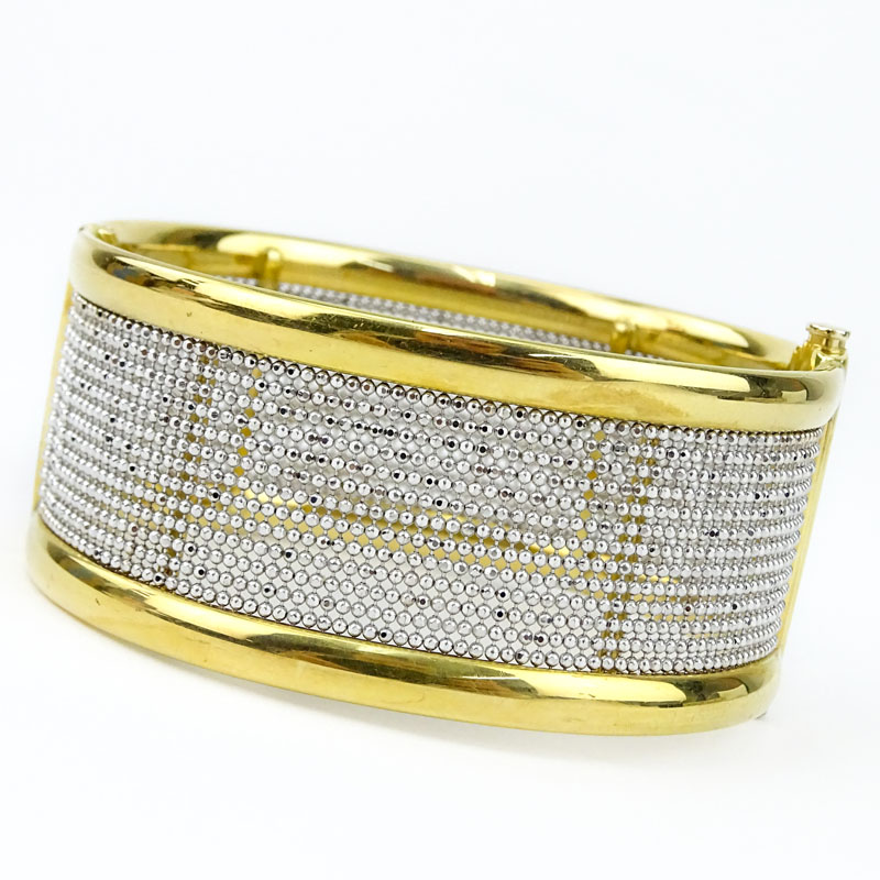 Finely Crafted Italian 18 Karat Yellow and White Gold Hinged Bangle Bracelet. Stamped Italy, 18K and maker's mark. 