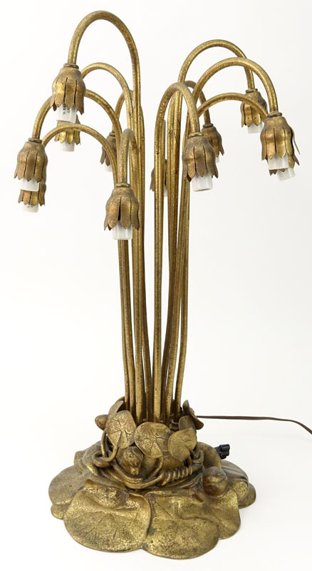 Important Tiffany Studios Twelve-Light Pond Lily Lamp. The pond lily base of dore bronze, the drop cluster blossom design shades in iridescent favrile glass. 