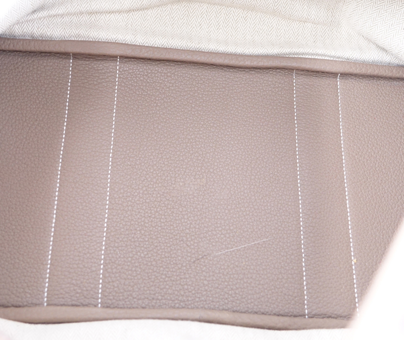 Hermes Etoupe Garden Party 36 Bag. Ivory herringbone fabric interior with zipper and patch pockets, snap closure.