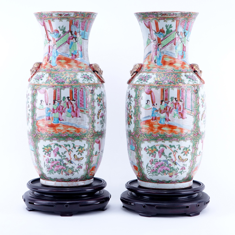 Large Pair of Antique Rose Medallion Porcelain Vases with Mock Foo Dog Ring Handles on Associated Bases.