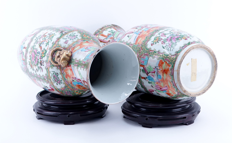 Large Pair of Antique Rose Medallion Porcelain Vases with Mock Foo Dog Ring Handles on Associated Bases.