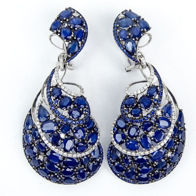 Approx. 40.0 Carat Pear Shape, Oval and Round Cut Sapphire and 18 Karat White Gold Earrings accented with approx. 1.20 Carat Round Brilliant Cut Diamonds. 