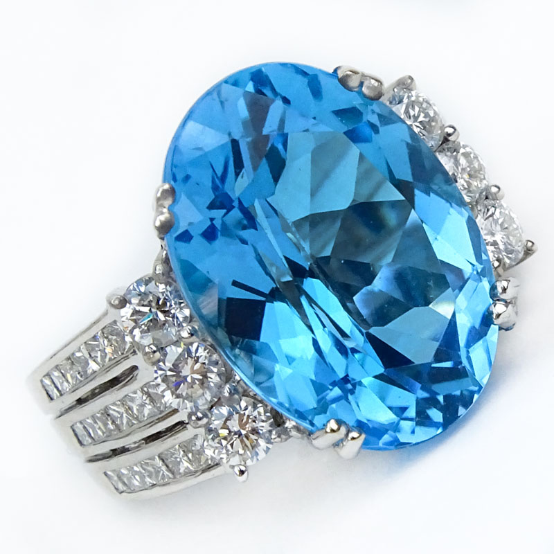 Approx. 15.0 Carat Oval Cut London Blue Topaz, 1.20 Carat Round Brilliant Cut Diamond and 18 Karat White Gold Ring.