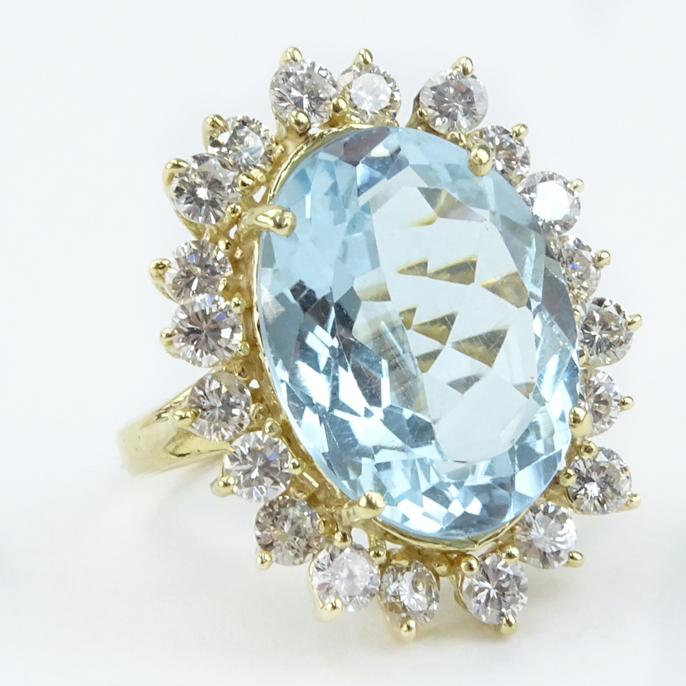 13.70 Carat Oval Cut Aquamarine,  2.25 Carat Round Brilliant Cut Diamond and 14 Karat Yellow Gold Ring. 