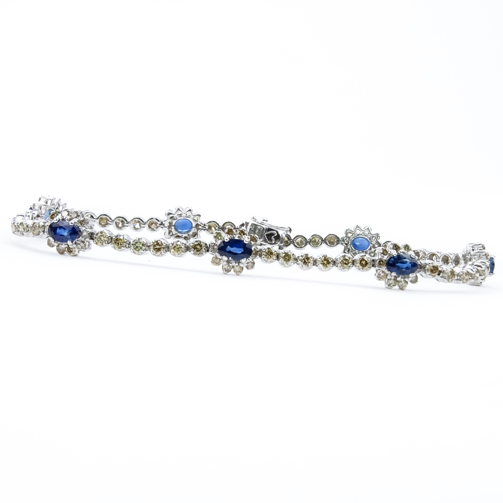  2.46 Carat Oval Cut Sapphire, 2.59 Carat Round Brilliant Cut Yellow Diamond and 18 Karat White Gold Bracelet. 