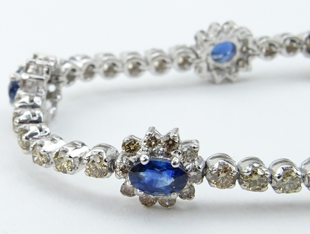  2.46 Carat Oval Cut Sapphire, 2.59 Carat Round Brilliant Cut Yellow Diamond and 18 Karat White Gold Bracelet. 