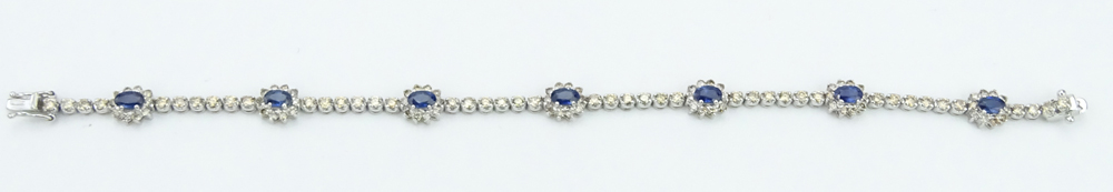  2.46 Carat Oval Cut Sapphire, 2.59 Carat Round Brilliant Cut Yellow Diamond and 18 Karat White Gold Bracelet. 