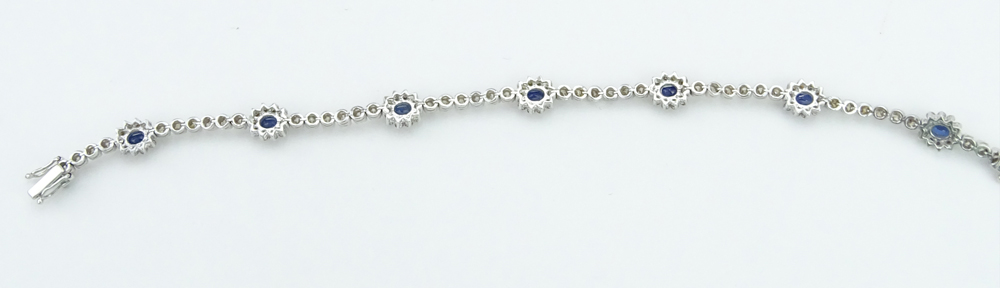  2.46 Carat Oval Cut Sapphire, 2.59 Carat Round Brilliant Cut Yellow Diamond and 18 Karat White Gold Bracelet. 