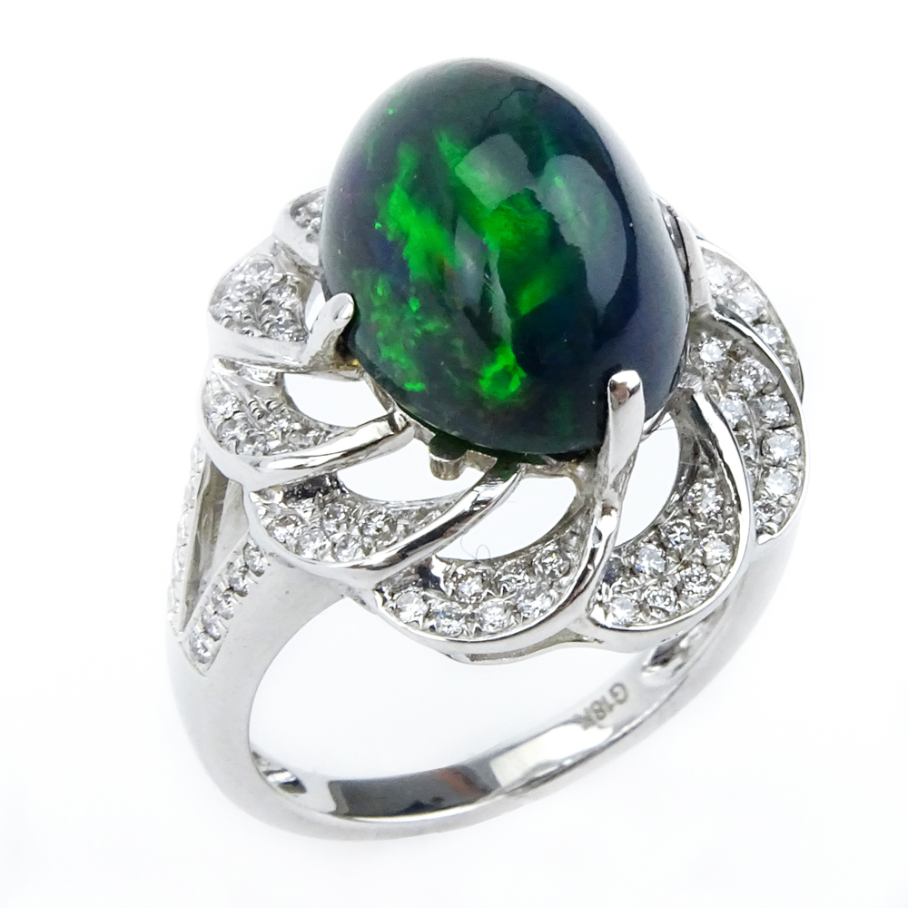 5.30 Carat Oval Cabochon Black Opal, 1.20 Carat Diamond and 18 Karat White Gold Ring. 