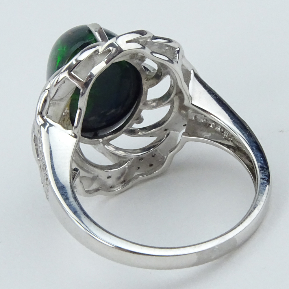 5.30 Carat Oval Cabochon Black Opal, 1.20 Carat Diamond and 18 Karat White Gold Ring. 