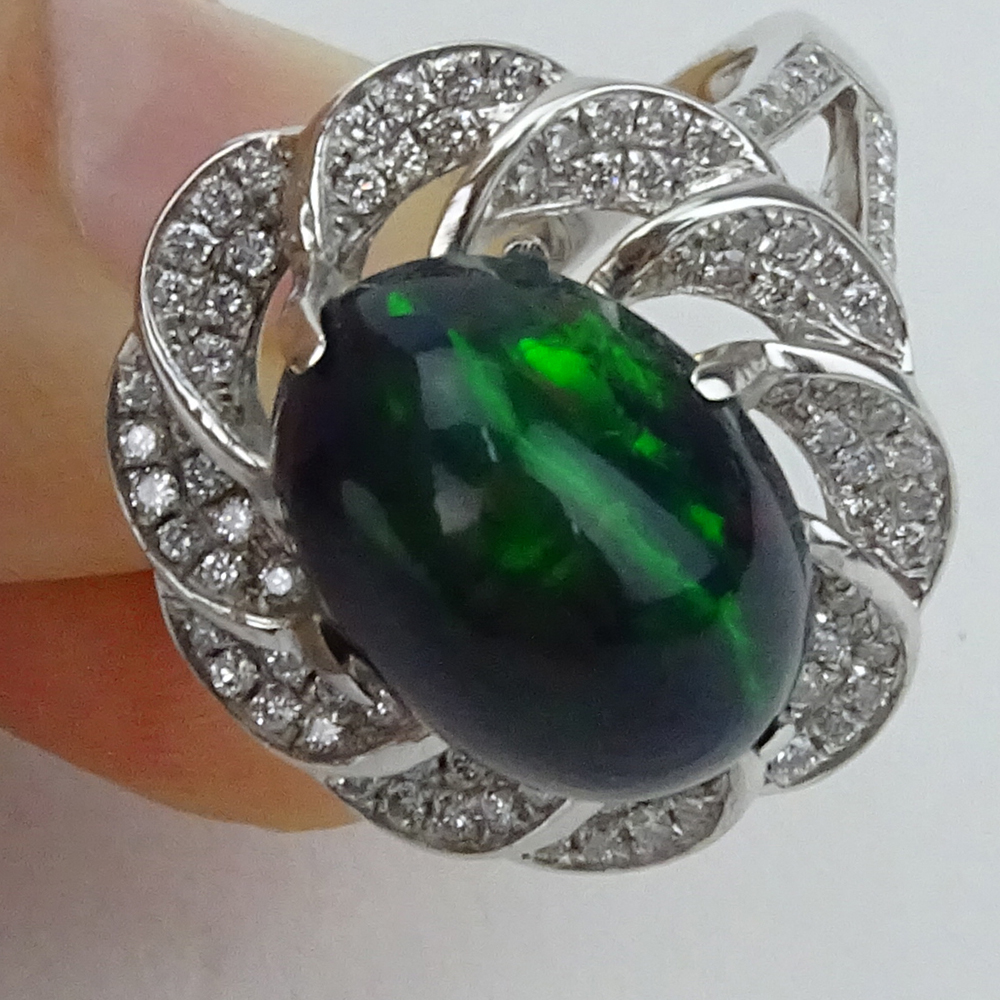 5.30 Carat Oval Cabochon Black Opal, 1.20 Carat Diamond and 18 Karat White Gold Ring. 