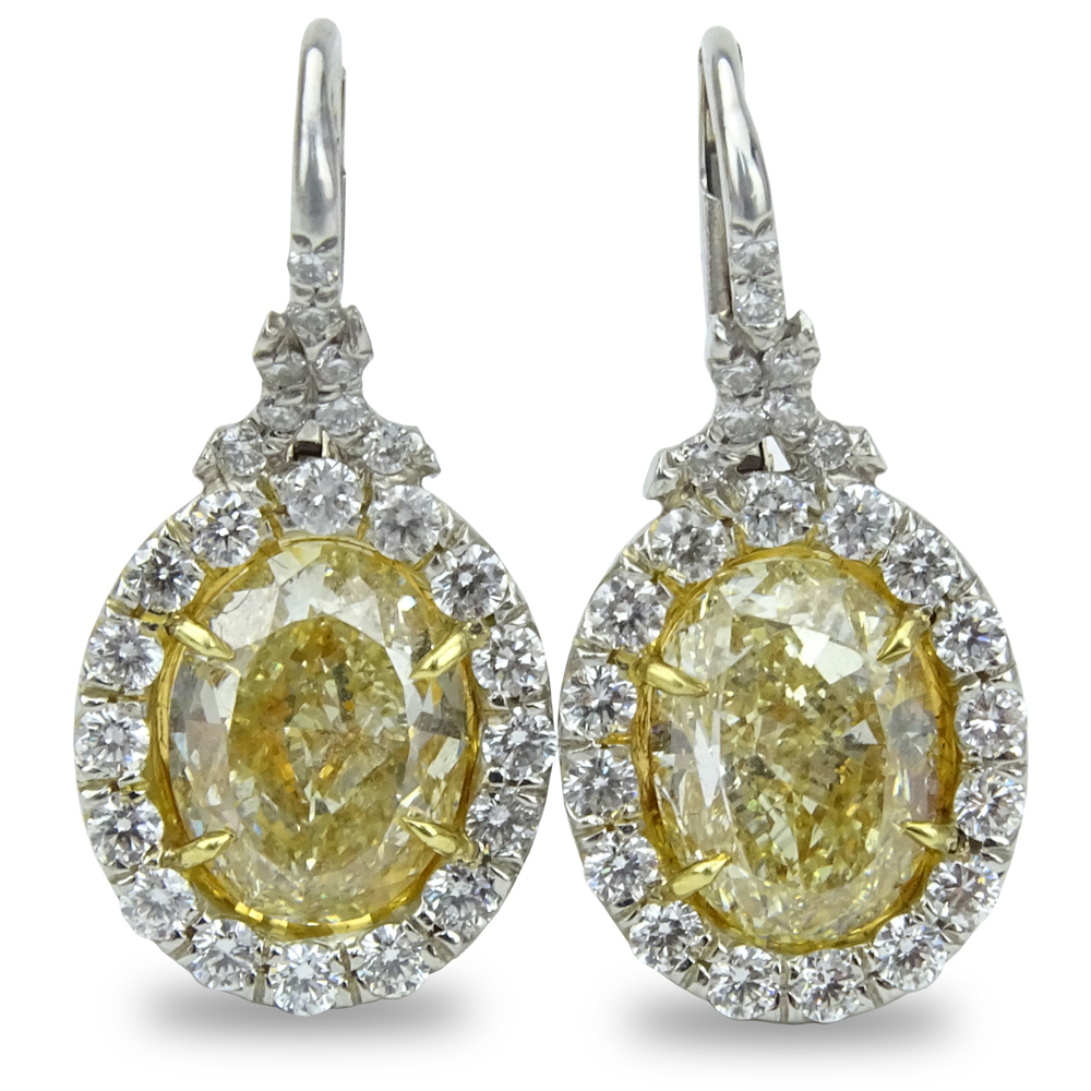 6.37 Carat Oval Cut Fancy Yellow Diamond, 1.19 Carat Round Brilliant Cut Diamond and Platinum and 18 Karat Yellow Gold Pendant Earrings.