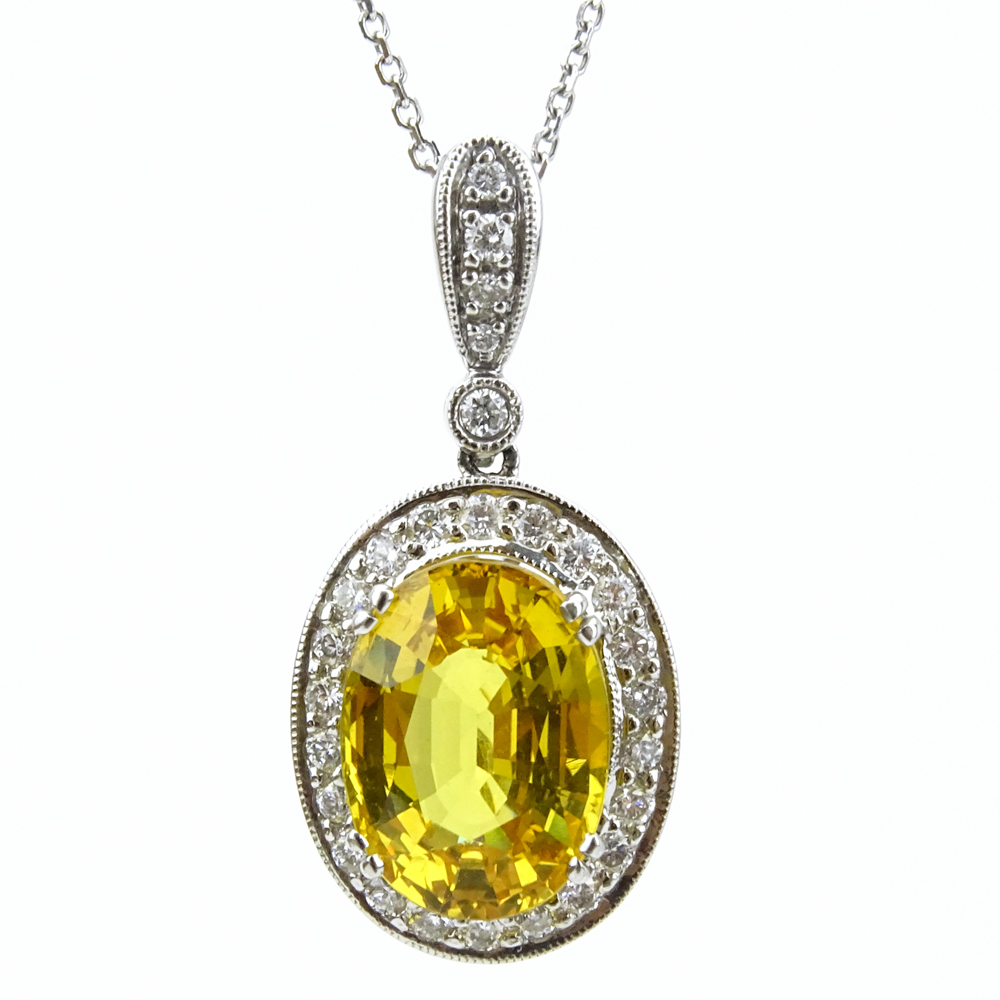 6.50 Carat Oval Cut Yellow Sapphire, .65 Carat Round Brilliant Cut Diamond and 18 Karat White Gold pendant Necklace. 