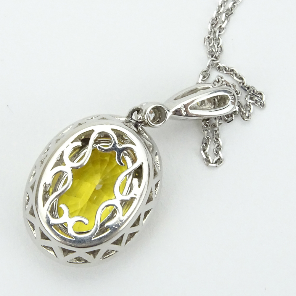 6.50 Carat Oval Cut Yellow Sapphire, .65 Carat Round Brilliant Cut Diamond and 18 Karat White Gold pendant Necklace. 