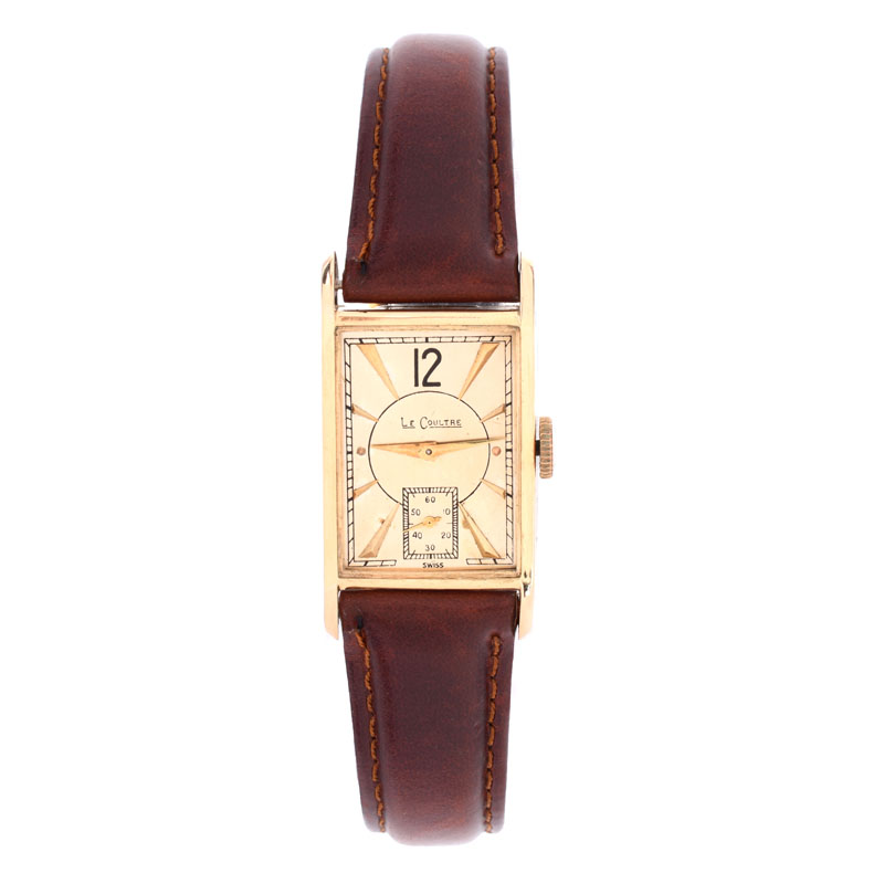 Lady's Vintage LeCoultre 14 Karat Yellow Gold Tank Watch with Leather Strap. Case measures 27mm x 20mm.