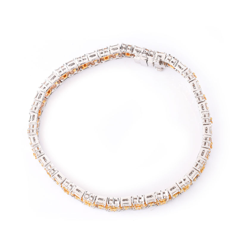 Approx. 3.90 Carat TW Round Brilliant and Baguette Cut White Diamond, 3.25 Carat Round Brilliant Cut Fancy Yellow Diamond and 18 Karat White Gold Bracelet. 