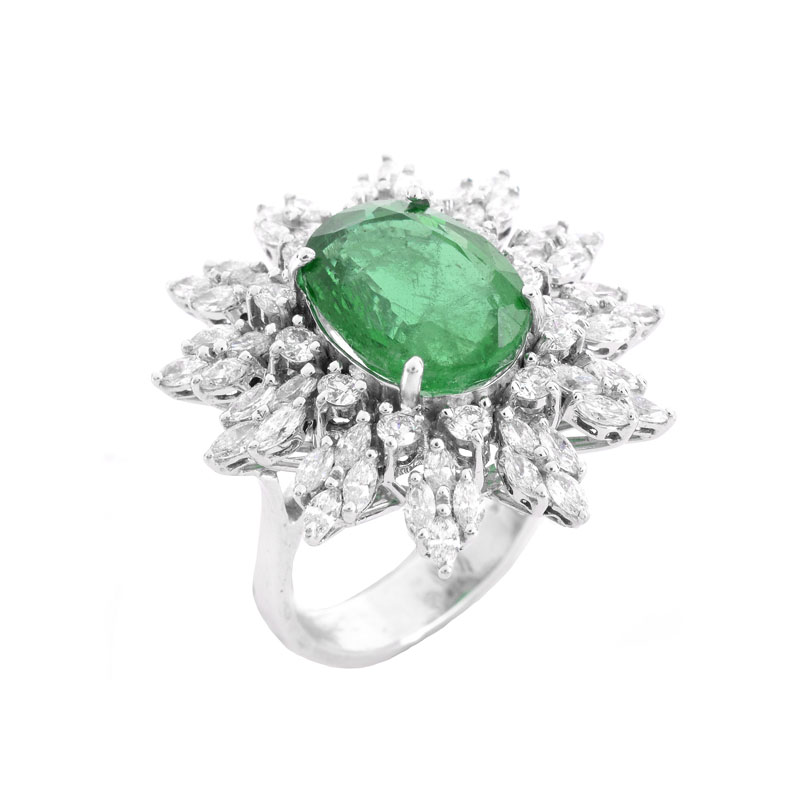 Approx. 5.30 Carat Oval Cut Emerald, 1.95 Carat TW Marquise and Round Brilliant Cut Diamond and 18 Karat White Gold Ring.