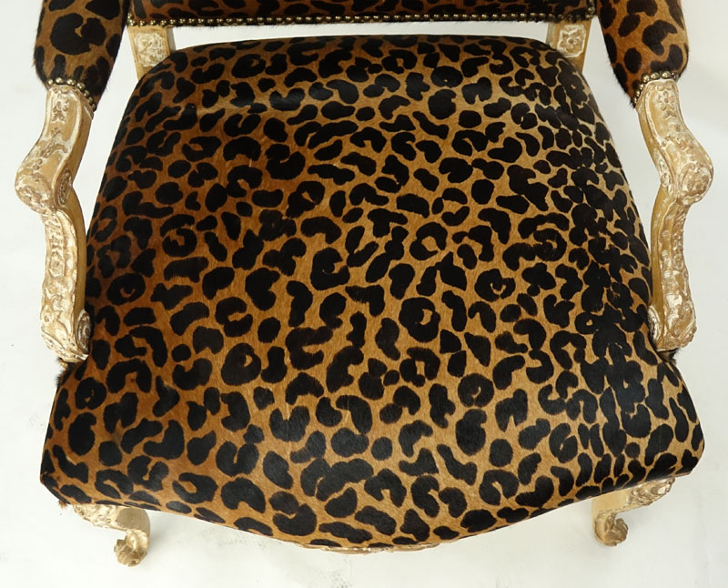 Vintage Cow-Hide Upholstered and Carved Wood Fauteuil Chair. Stencil cheetah print on upholstery and distressed floral carved frame.