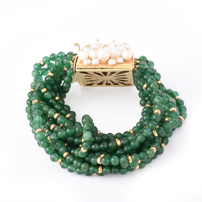 Circa 1950s Multi Strand Emerald Bead, Pearl and 18 Karat Yellow Gold Bracelet. Emerald beads measure 4mm.