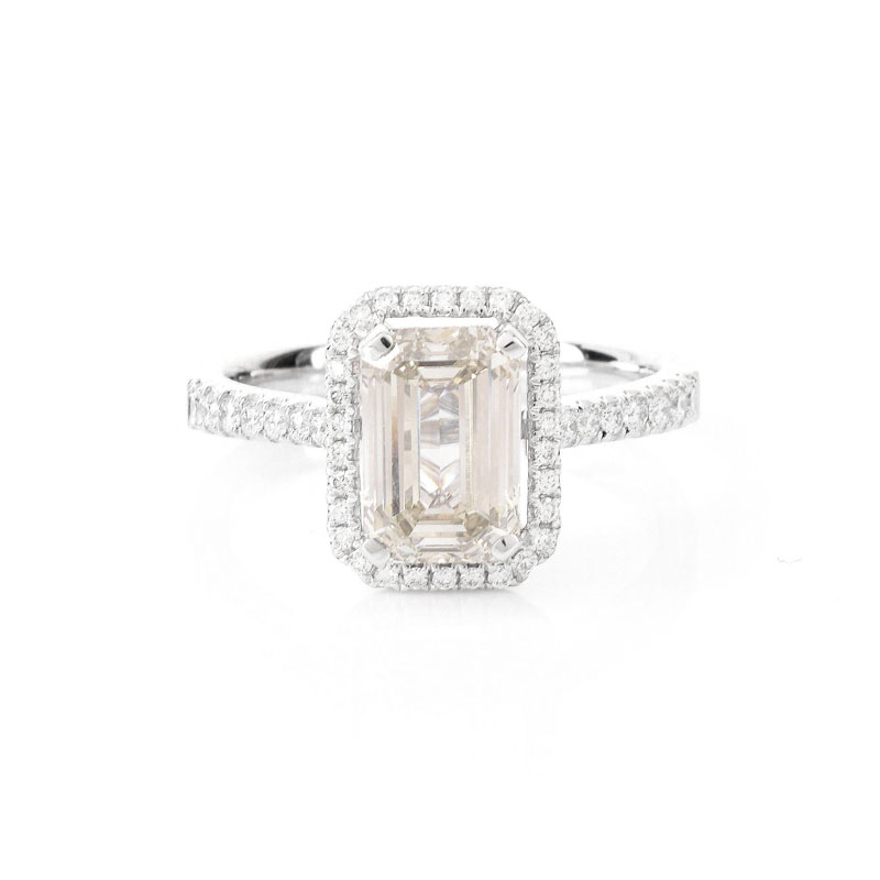 Approx. 2.10 Carat Emerald Cut Diamond and 18 Karat White Gold Engagement Ring accented throughout with Round Brilliant Cut Diamonds.