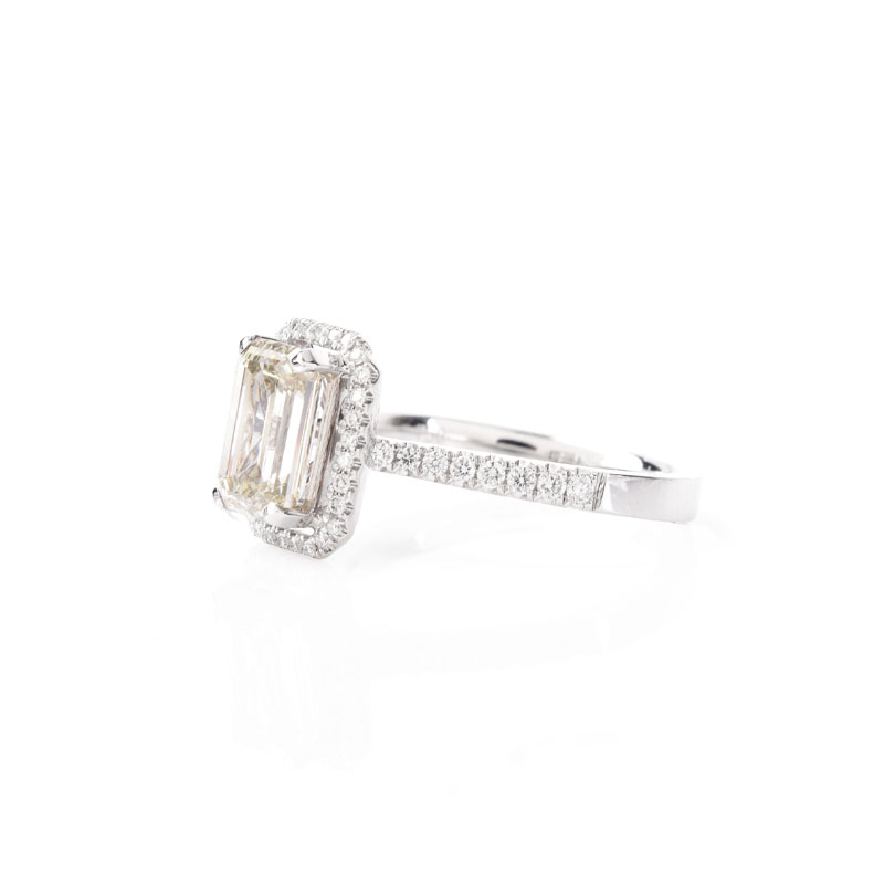 Approx. 2.10 Carat Emerald Cut Diamond and 18 Karat White Gold Engagement Ring accented throughout with Round Brilliant Cut Diamonds.