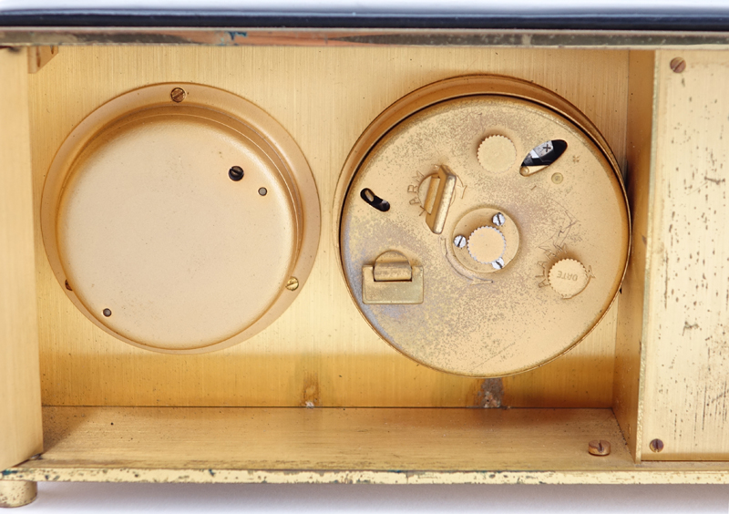 Two Brass Clocks. A Tiffany & Co. round quartz clock, inscribed "To Jay From Normie 12-11-81"; a Saks brass and leather Swiss desk clock with temperature and barometer. 