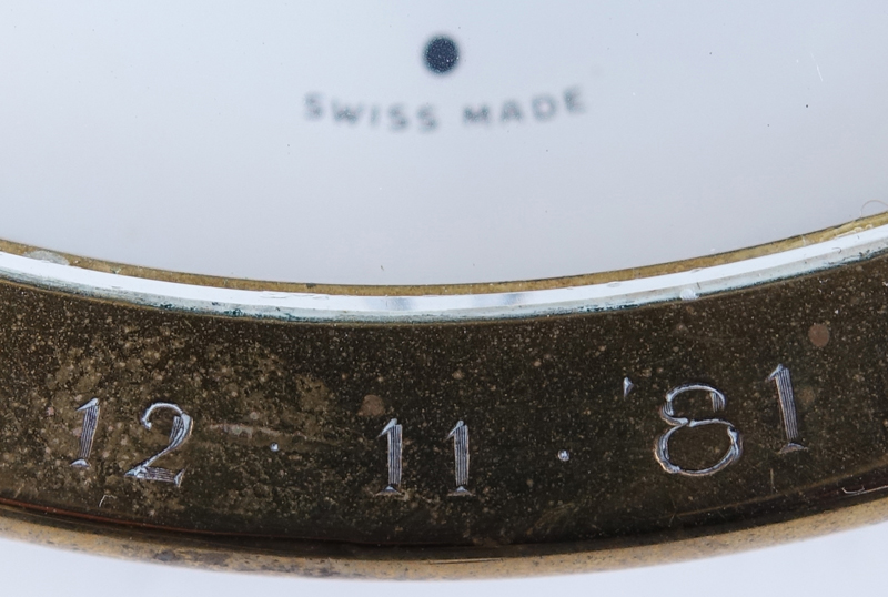 Two Brass Clocks. A Tiffany & Co. round quartz clock, inscribed "To Jay From Normie 12-11-81"; a Saks brass and leather Swiss desk clock with temperature and barometer. 