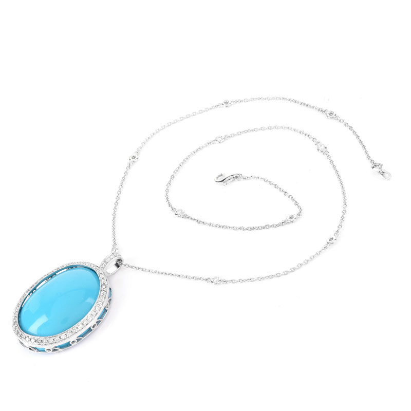 Large Oval Cabochon Persian Turquoise, 1.50 Carat Round Brilliant Cut Diamond and 18 Karat White Gold Pendant with 14 Karat White Gold Chain. Pendant stamped 18K 750, chain stamped 14K. 