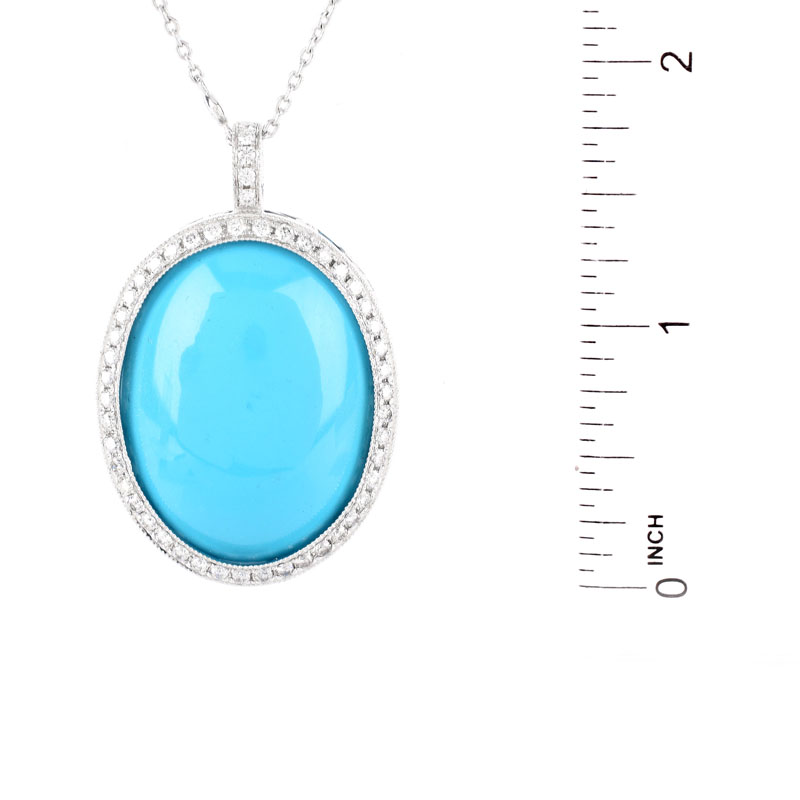 Large Oval Cabochon Persian Turquoise, 1.50 Carat Round Brilliant Cut Diamond and 18 Karat White Gold Pendant with 14 Karat White Gold Chain. Pendant stamped 18K 750, chain stamped 14K. 
