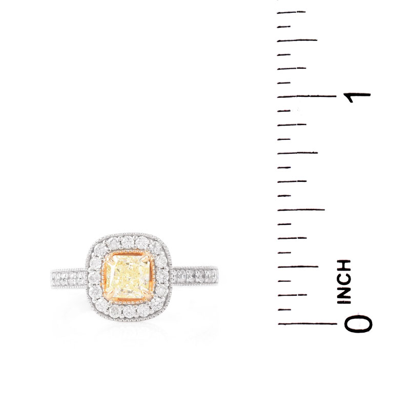 GIA Certified .59 Carat Fancy Yellow Diamond, .65 Carat Round Brilliant Cut Diamond and 18 Karat White and Yellow Gold Engagement Ring. Yellow diamond SI2 clarity.