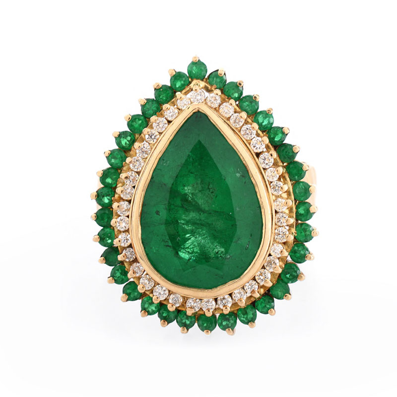 Approx. 7.50 Carat Pear Shape Colombian Emerald and 18 Karat Yellow Gold Ring accented with .50 Carat Round Brilliant Cut Diamonds and 2.0 Carat Round Cut Emeralds.