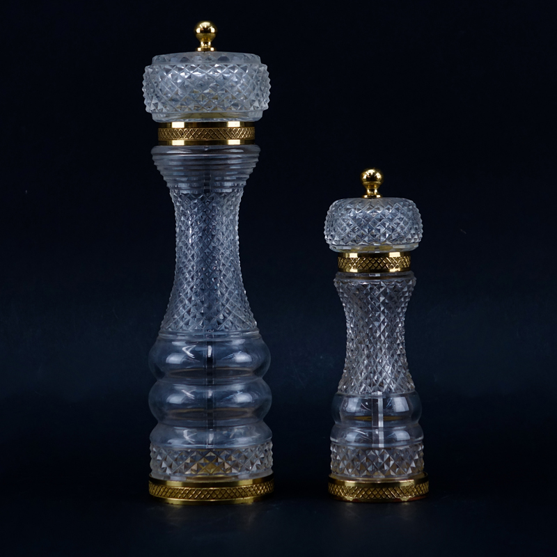 Two Baccarat Style Crystal And Brass Pepper Mills. Unsigned. Wear and in need of cleaning.