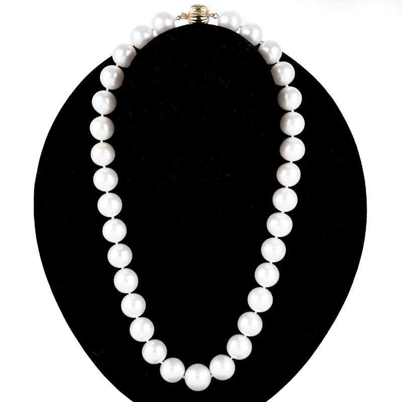 Single Strand Thirty Three (33) 13-15mm South Sea Pearl Necklace with 14 Karat Yellow Gold Clasp.