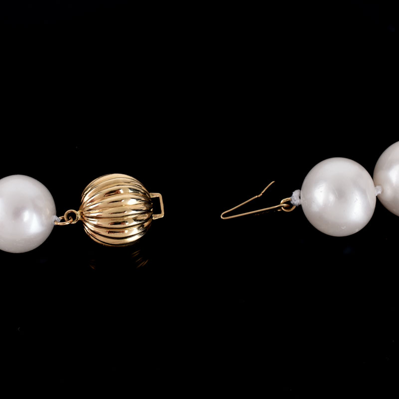 Single Strand Thirty Three (33) 13-15mm South Sea Pearl Necklace with 14 Karat Yellow Gold Clasp.